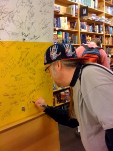 Jay Lake signing the author wall at Powell's